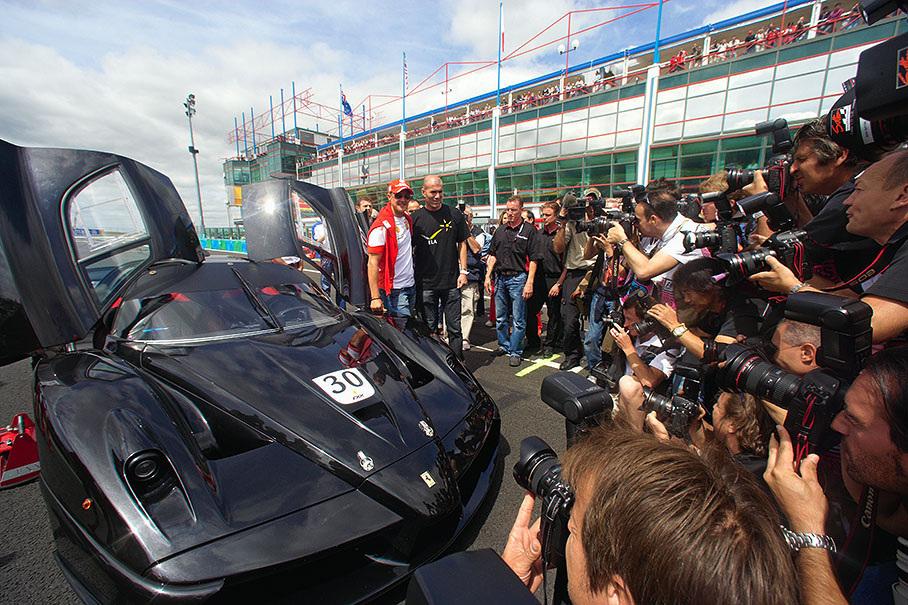Memorable soccer star Zinedine Zidane receives a test drive on a special Ferrari Enzo from Michael Schumacher around the circuit as a promotional press event initiating fondraising for a new building project. Ferrari director Jean Todt: "ICM is a foundation of which I am one of the founders. It's a medical foundation for research on the brain and spinal cord." (Formula1.com)