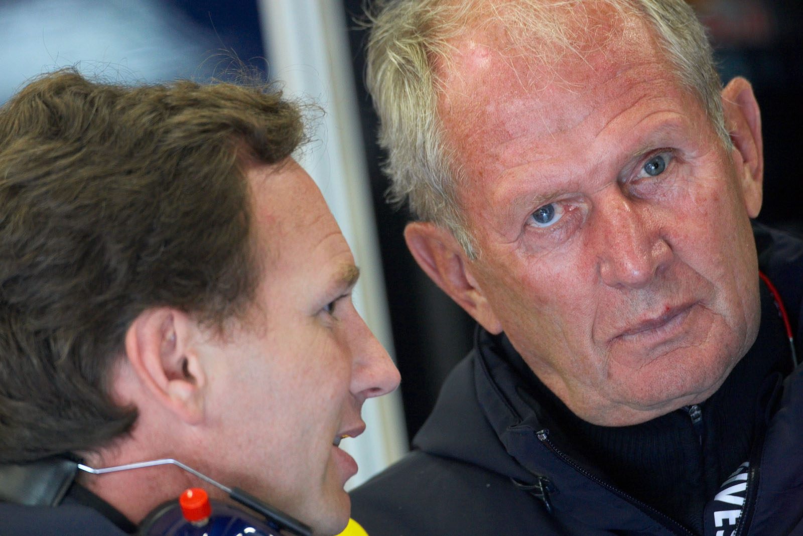 Red Bull advisor Dr. Helmut Marko listens to team boss Christian Horner in the pits
