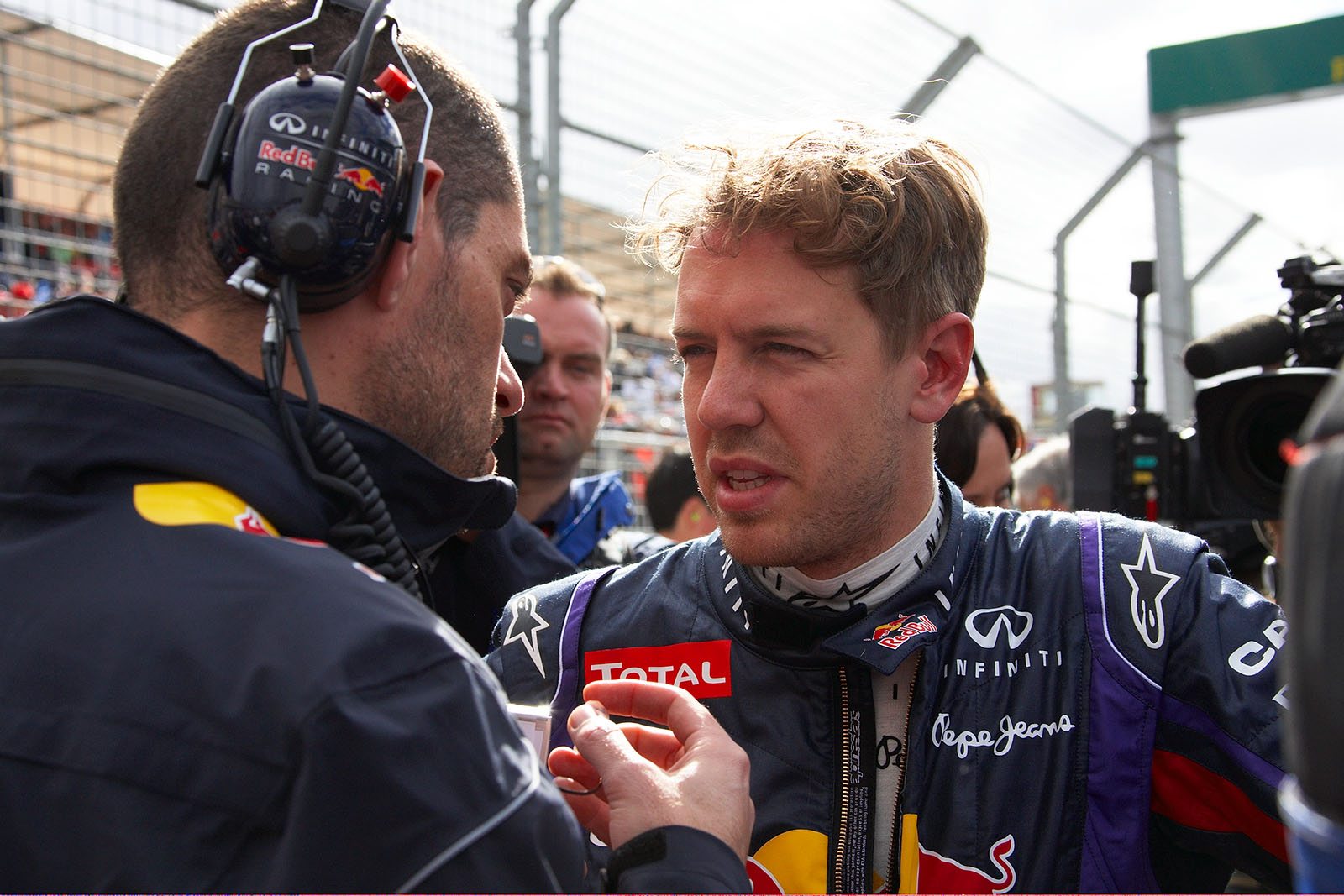 Sebastian Vettel listens to Red Bull Racing engineer Guillaume Rocquelin besides the grid before the race