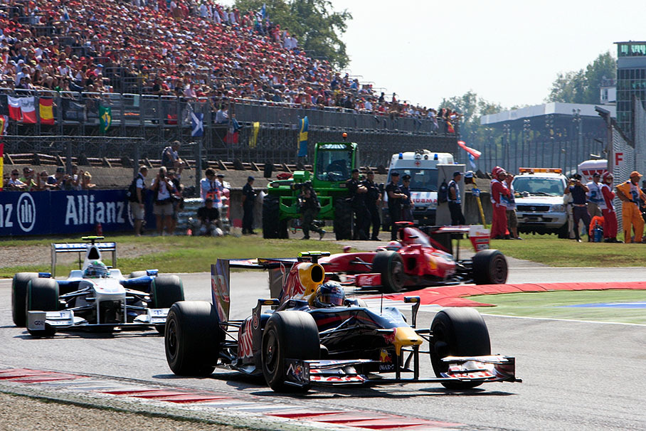 Red Bull Racing's Sebastian Vettel at the first chicane in front of Heidfeld and Fisichella