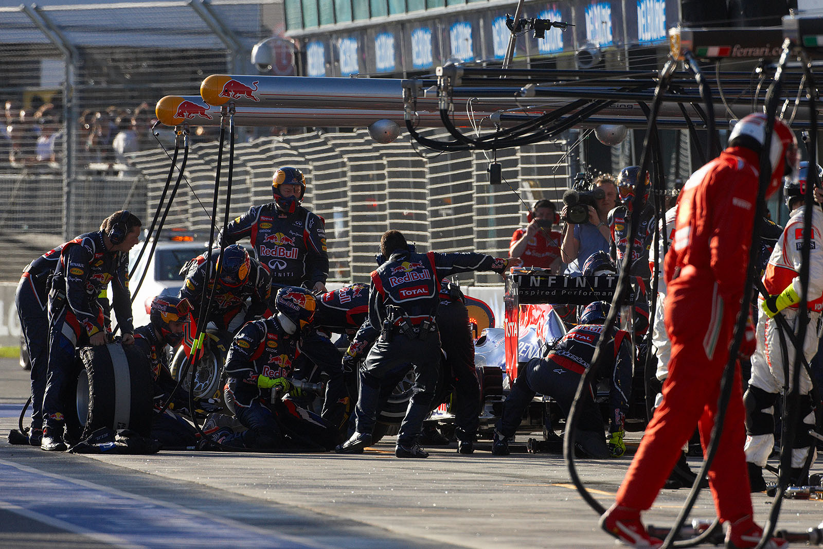 Sebastian Vettel stops briefly at Red Bull Racing pits