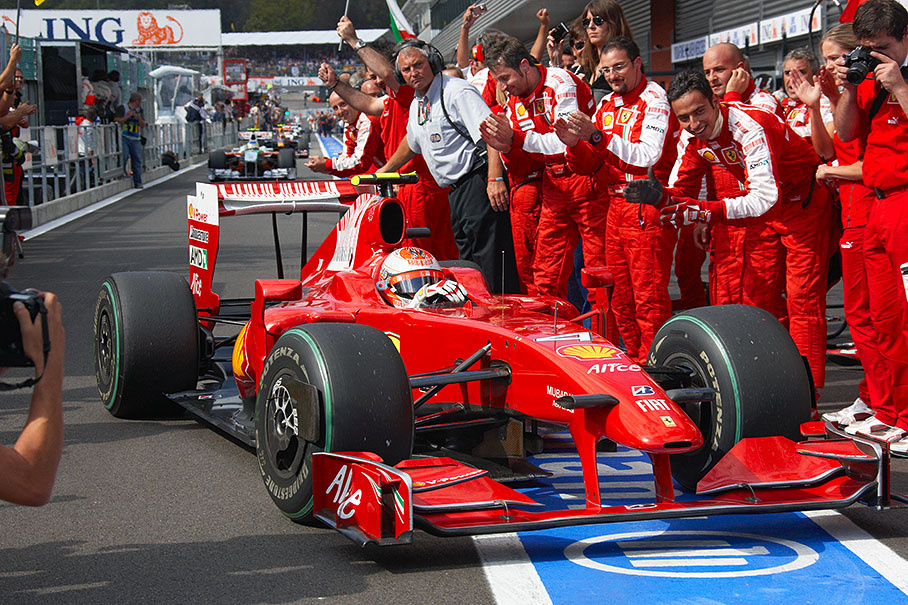 Race winner Kimi Raikkonen approaches parc ferme through an applauding Ferrari team