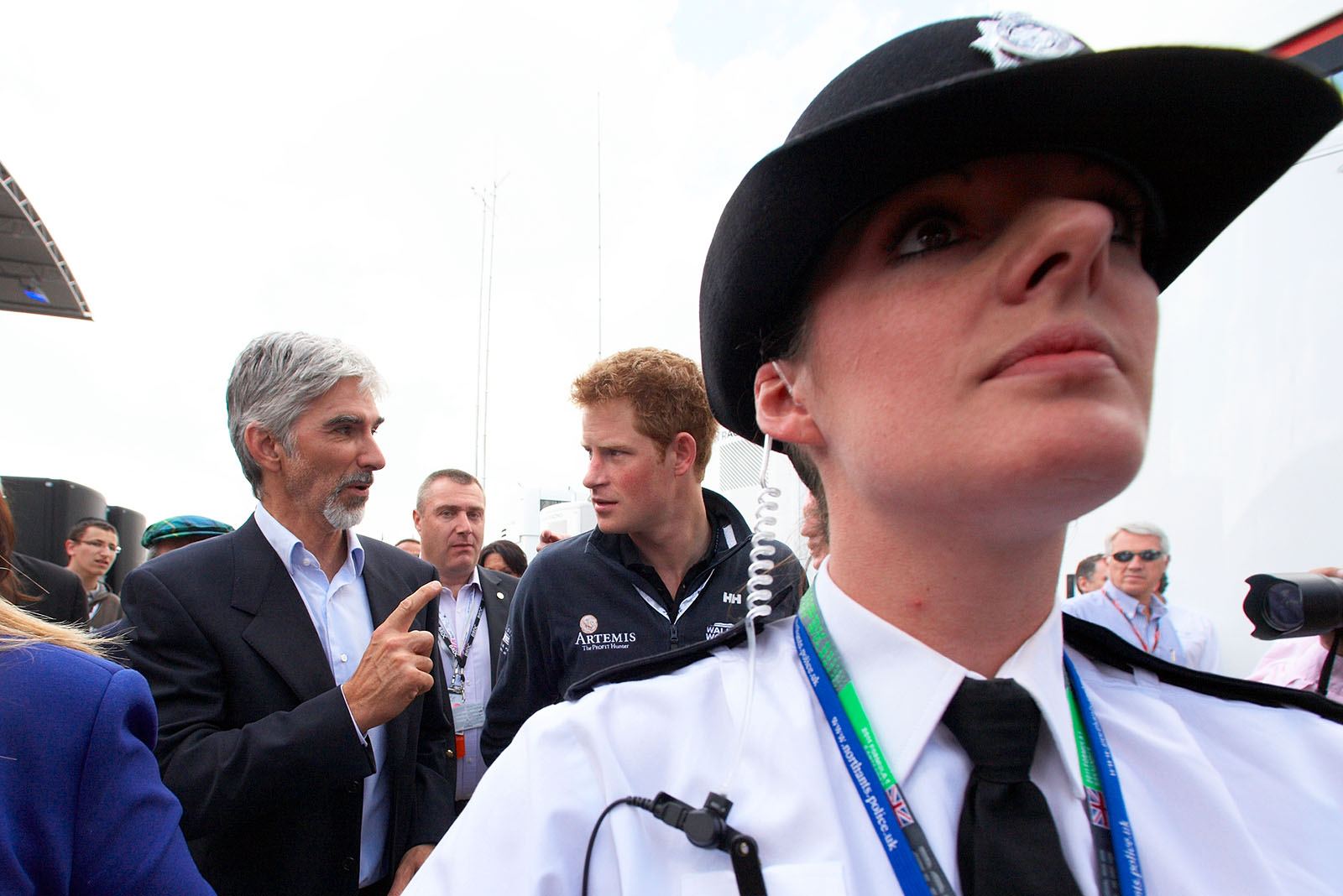 Resigned BRDC president Damon Hill walks through the paddock with Prince Henry 'Harry' of Wales