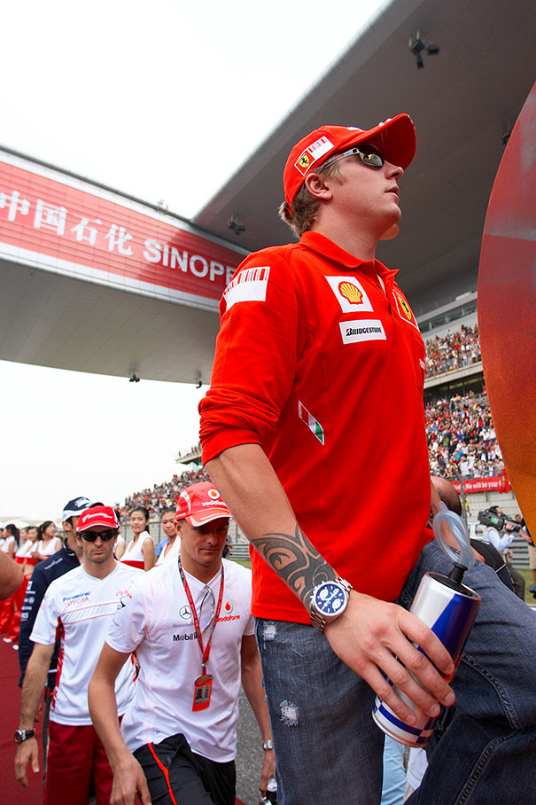 Kimi Raikkonen climbs on the drivers parade truck