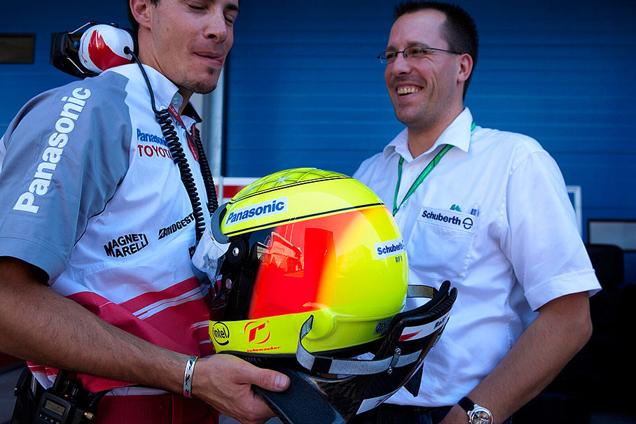 Sven Krieter of Schuberth takes care of Ralf Schumacher's helmet