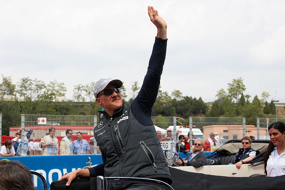 Michael Schumacher waves at the fans during drivers parade