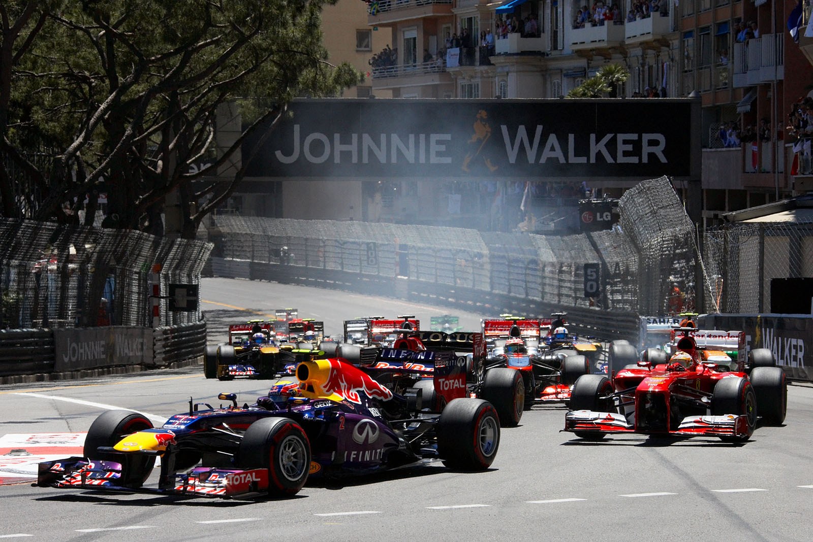 The start field approaches turn one, Webber as fourth in front of Raikkonen and Alonso