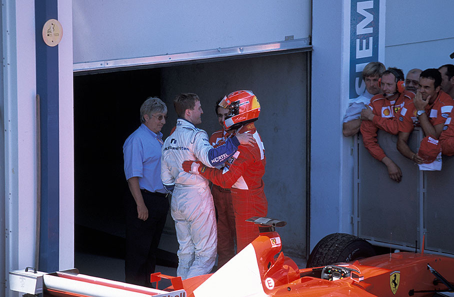 Race winner Michael Schumacher with his second placed brother Ralf in parc fermé