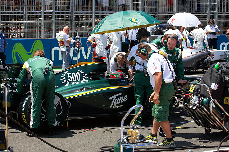 Jarno Trulli with his Lotus Racing crew swarmig around him