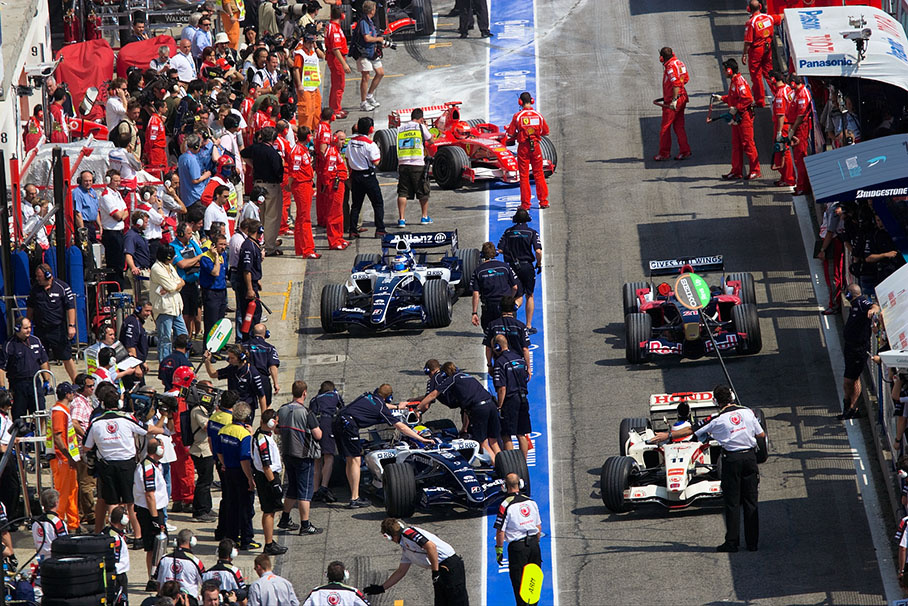 Busy Friday afternoon during second practice session in the pit lane - pit crews training with Webber, Rosberg, Barrichello and Speed