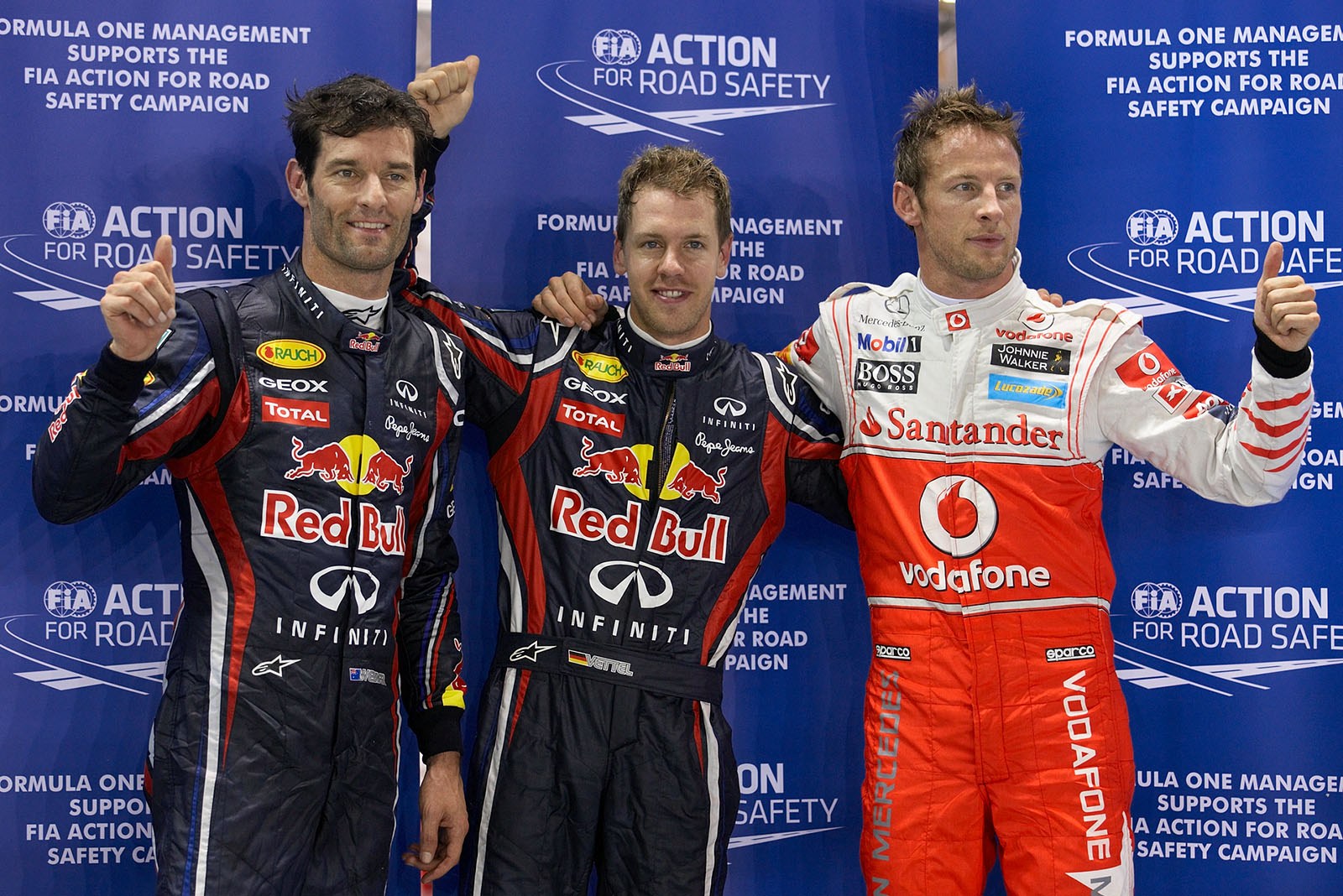 The fastest three qualifiers wave at the world's media: on the right hand third qualified McLaren's Jenson Button, Red Bull driver Sebastian Vettel as polesetter in the middle and his team mate Mark Webber as second on the grid on the left