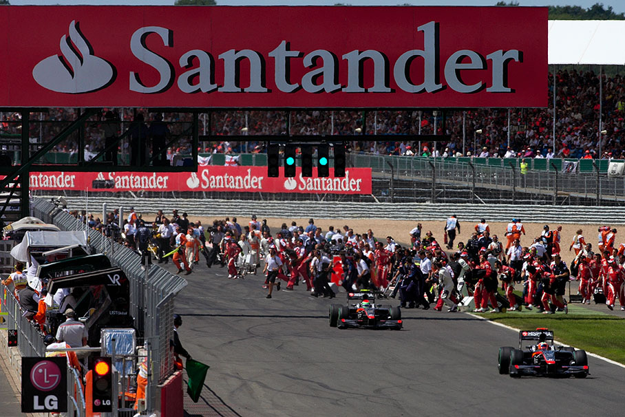 F1 team personnel crosses the main straight after the field left for formation lap