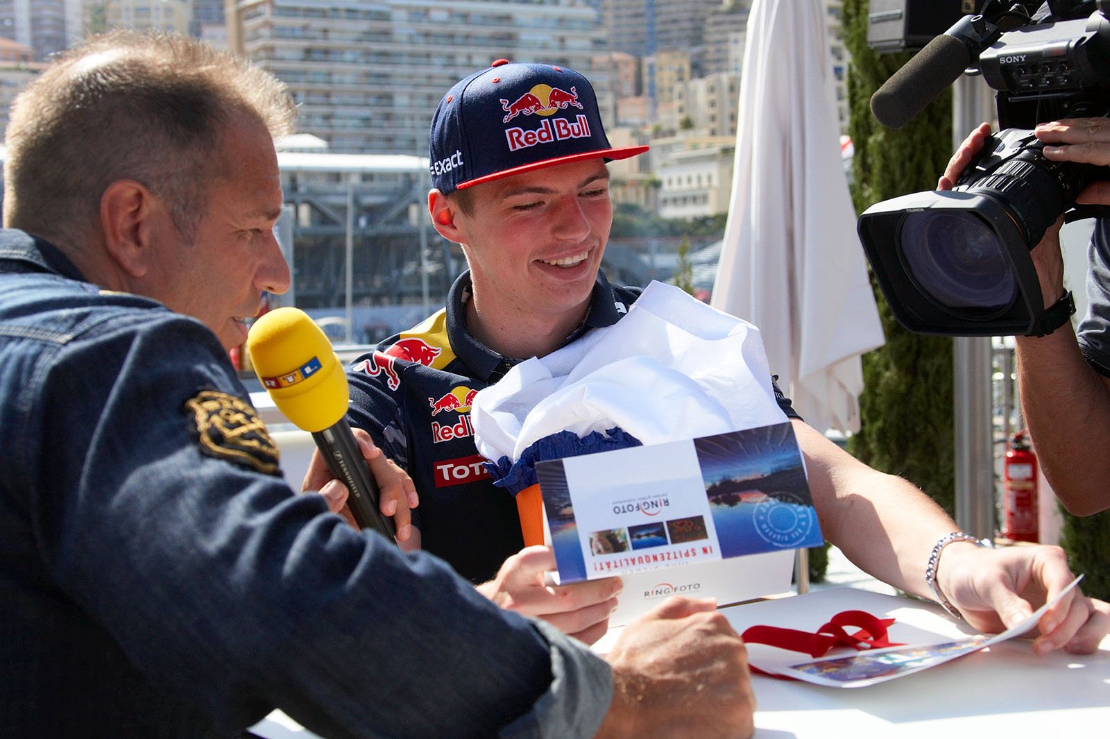 Dutsh Red Bull driver Max Verstappen looks at a photograph of himself as a little boy along with the great Michael Schumacher, Monte Carlo Grand Prix, 2016