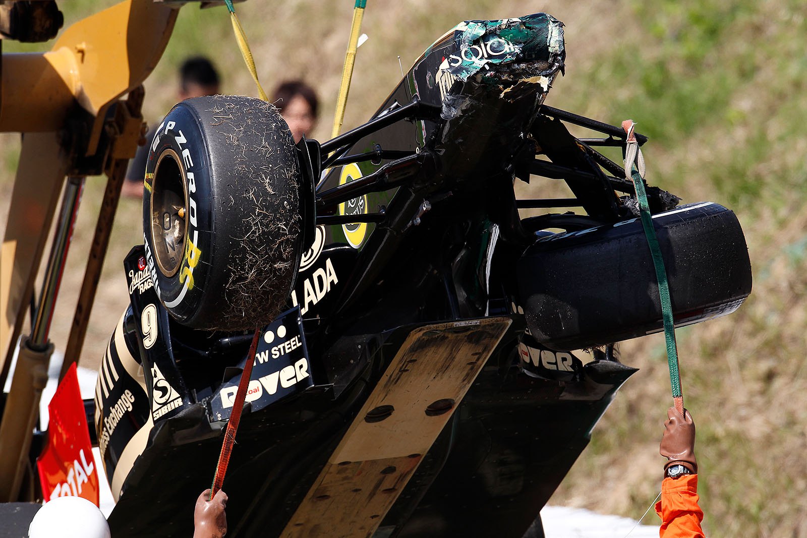 Bruno Senna's damaged Lotus Renault GP car is removed from the track during practice session
