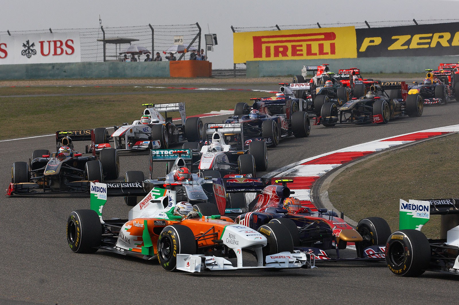 Adrian Sutil and Jaime Alguersuari in the middle of the start field