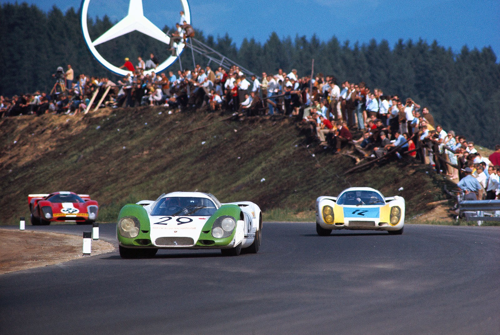 1000 km Zeltweg 1969: The winning Porsche 917 009 with Jo Siffert (CH) and Kurt Ahrens, Jr. (D) in front of Helmut Krause's (D) and Hans-Dieter Weigel's (D) Porsche 907 2.2 029 and the Lola T70 Mk.3B GT Chevrolet SL76/151 driven by Jo Bonnier (S) and Herbert M¸ller (CH)
