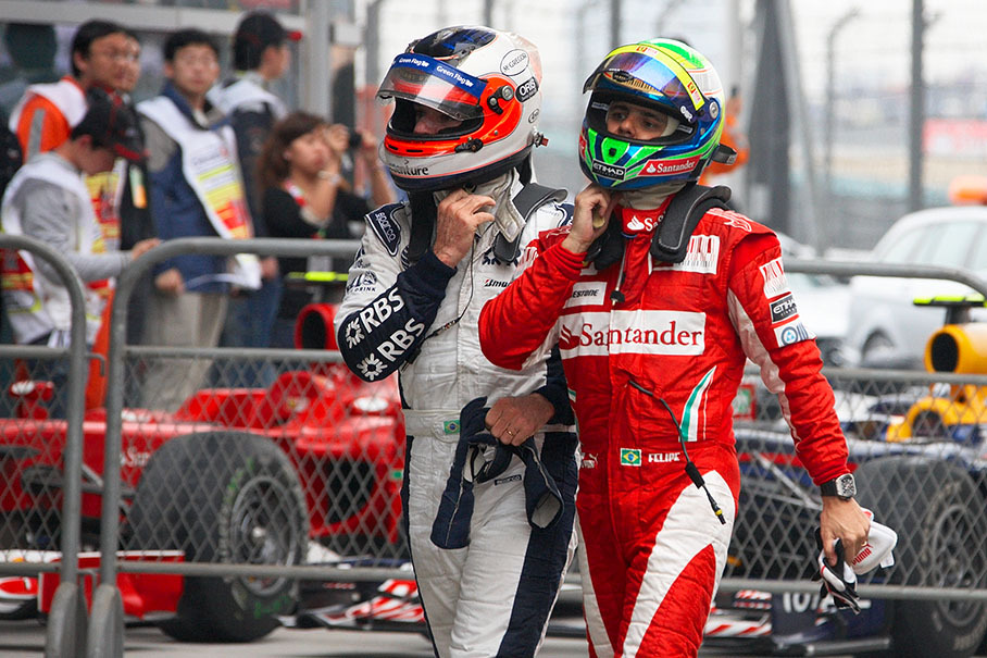 12th placed Rubens Barrichello with 9th positioned Felipe Massa walk together after the race