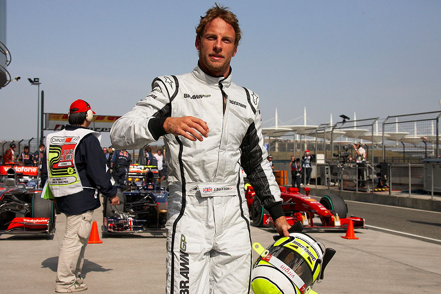 Fifth grid positioned Jenson Button walks behind parc ferme after Q3