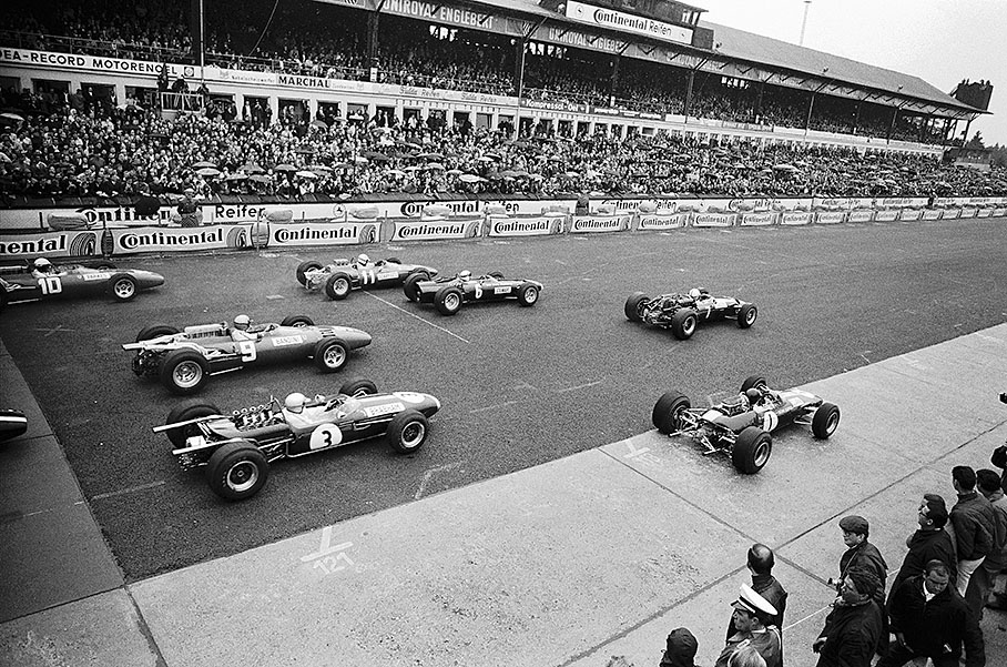 Start for the 6th race of the 1966 Formula 1 season on a damp Nurburgring track with John Surtees, Cooper no. 7, in the lead followed by polesetter Jim Clark, Lotus no. 1, Jackie Stewart's BRM, and Scarfiotti's Ferrari