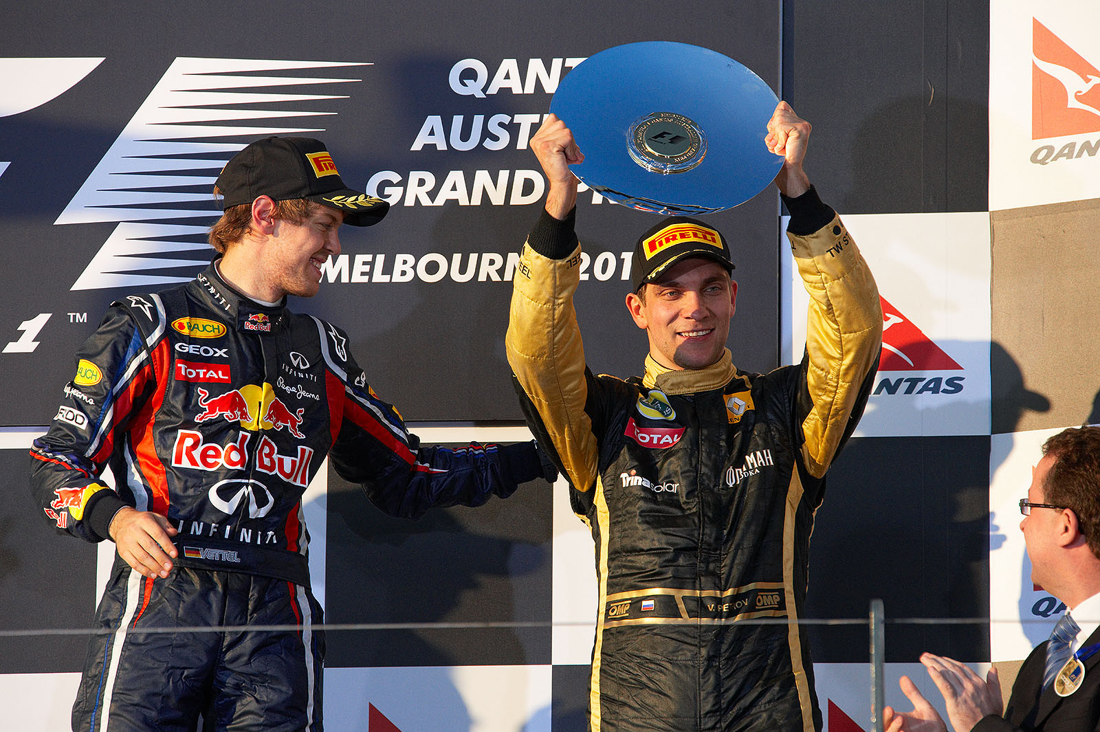 A very proud third placed Vitaly Petrov raises his trophy on the podium