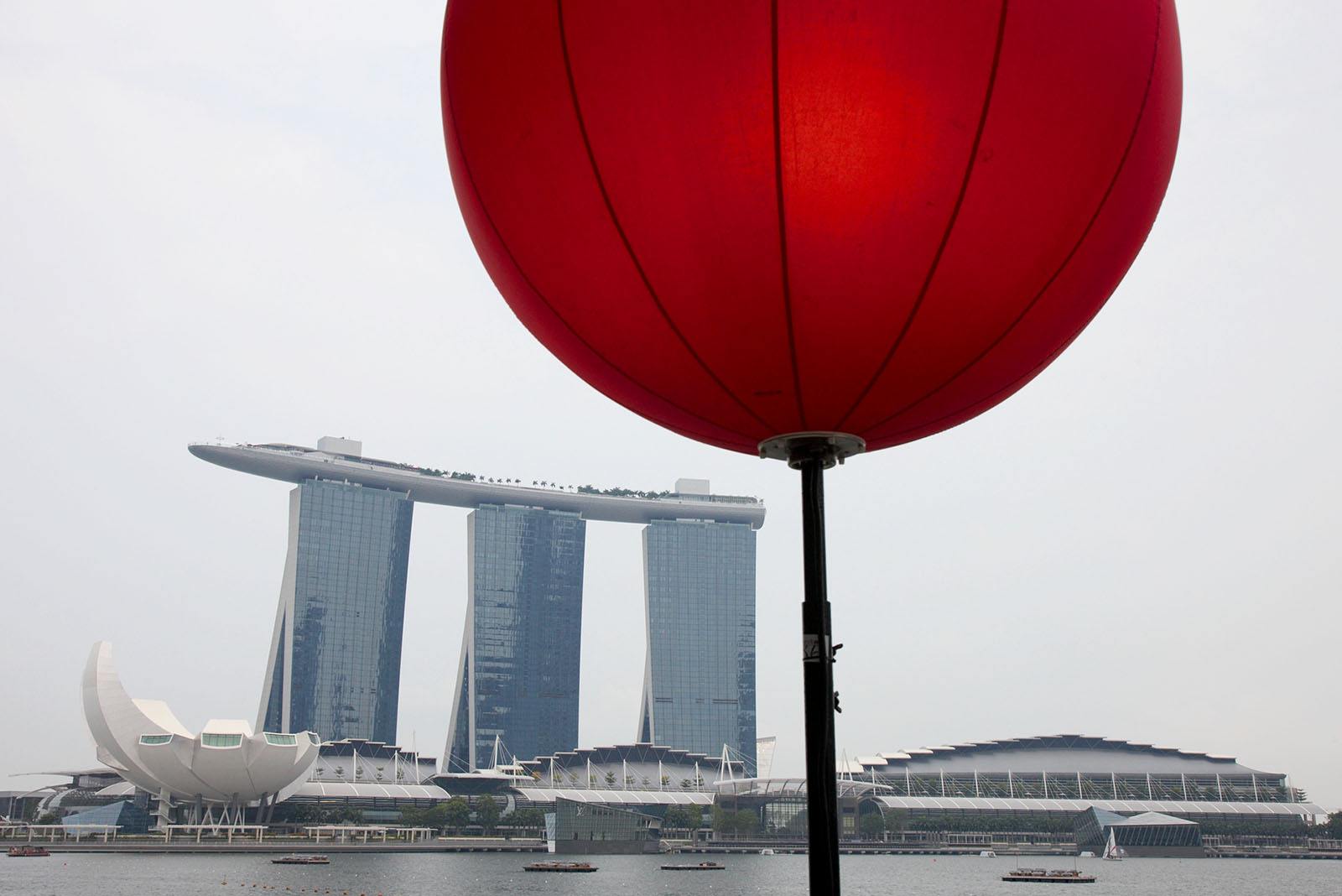 The famous Singapore Marina Bay Sands Hotel with the world's highest swimming pool watches over the race track
