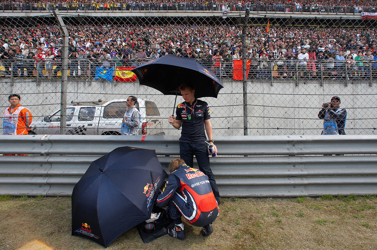 Red Bull champion Sebastian Vettel and his physio Tommi Parmakoski prepare for the race besides the grid