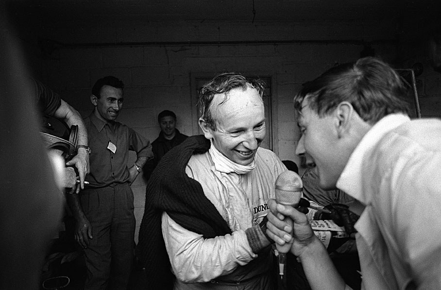 Race winner John Surtees is interviewed by the Austrian journalist Heinz Prueller after the 1966 Belgium Grand Prix