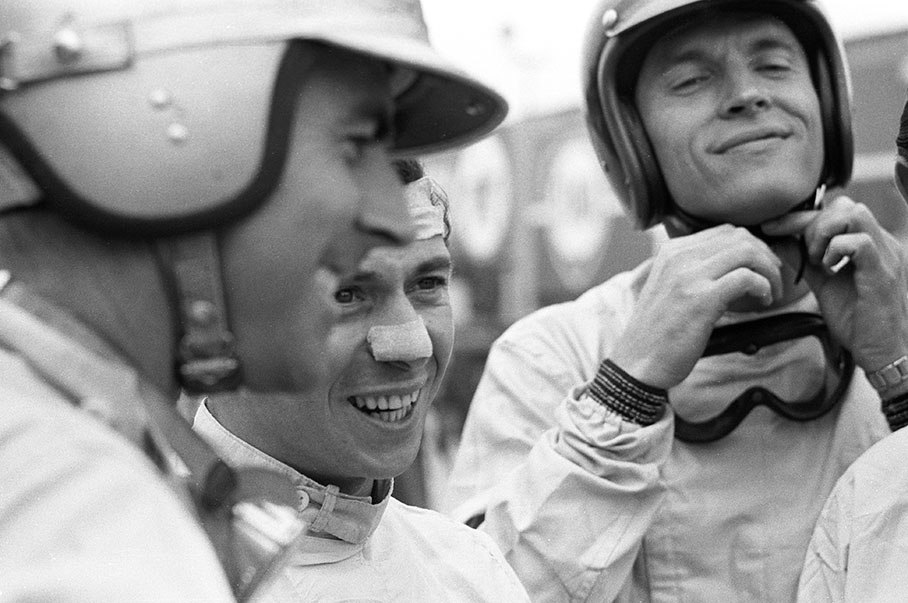 Jim Clark smiles during drivers briefing before the Italian GP, with Jack Brabham and Dan Gurney, Monza 1963