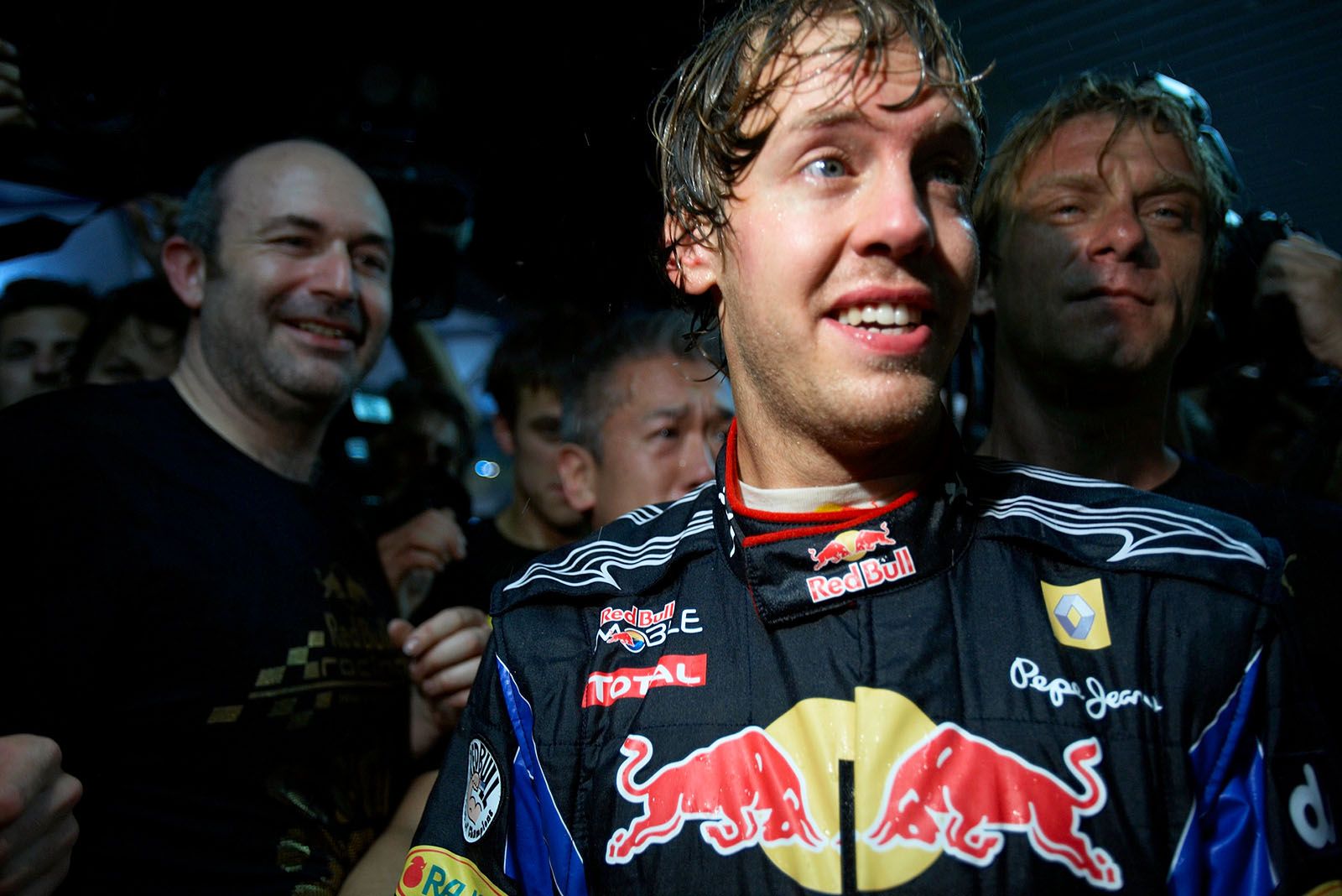 Sebastian Vettel celebrates with the Red Bull team