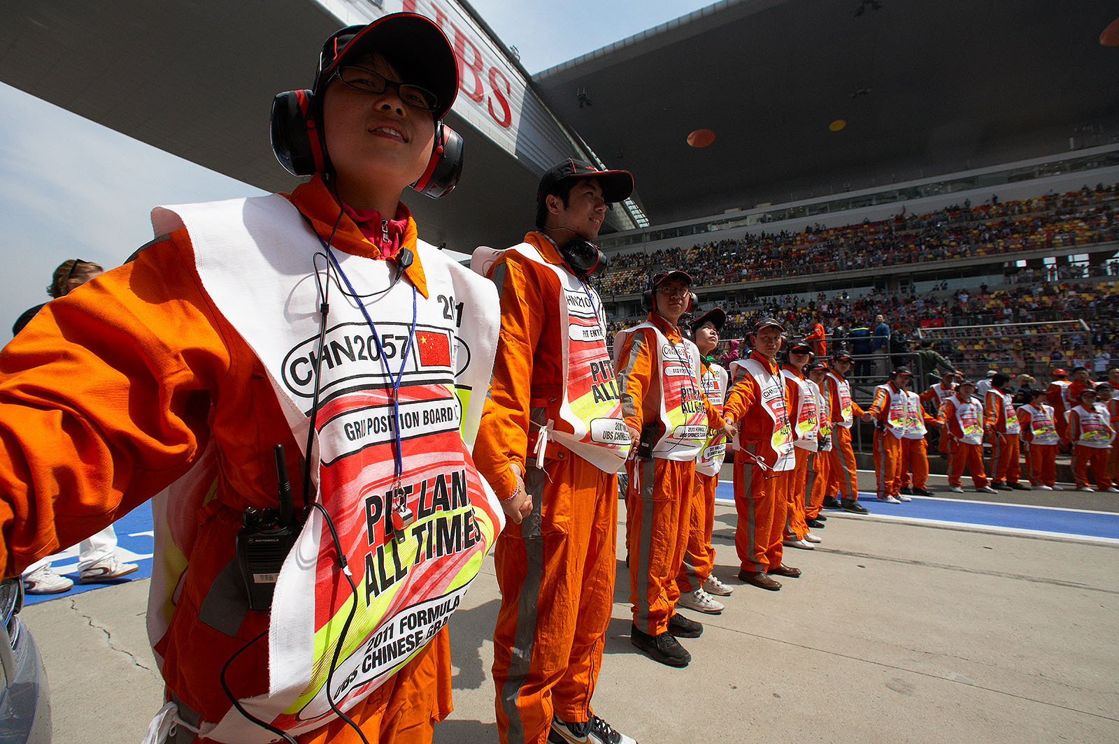 The pitlane marshals stand in line for the drivers parade