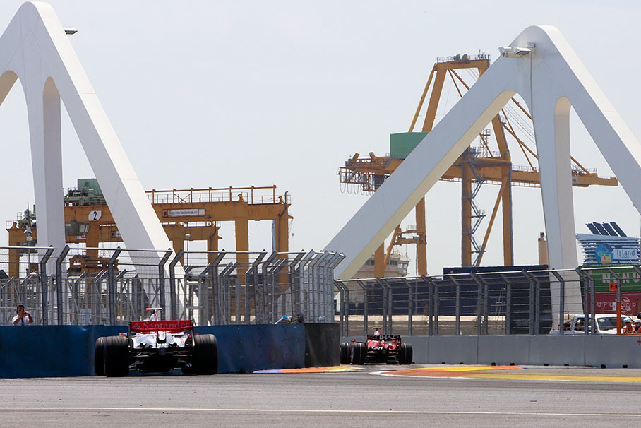 A Ferrari followed by a McLaren towards the bridge