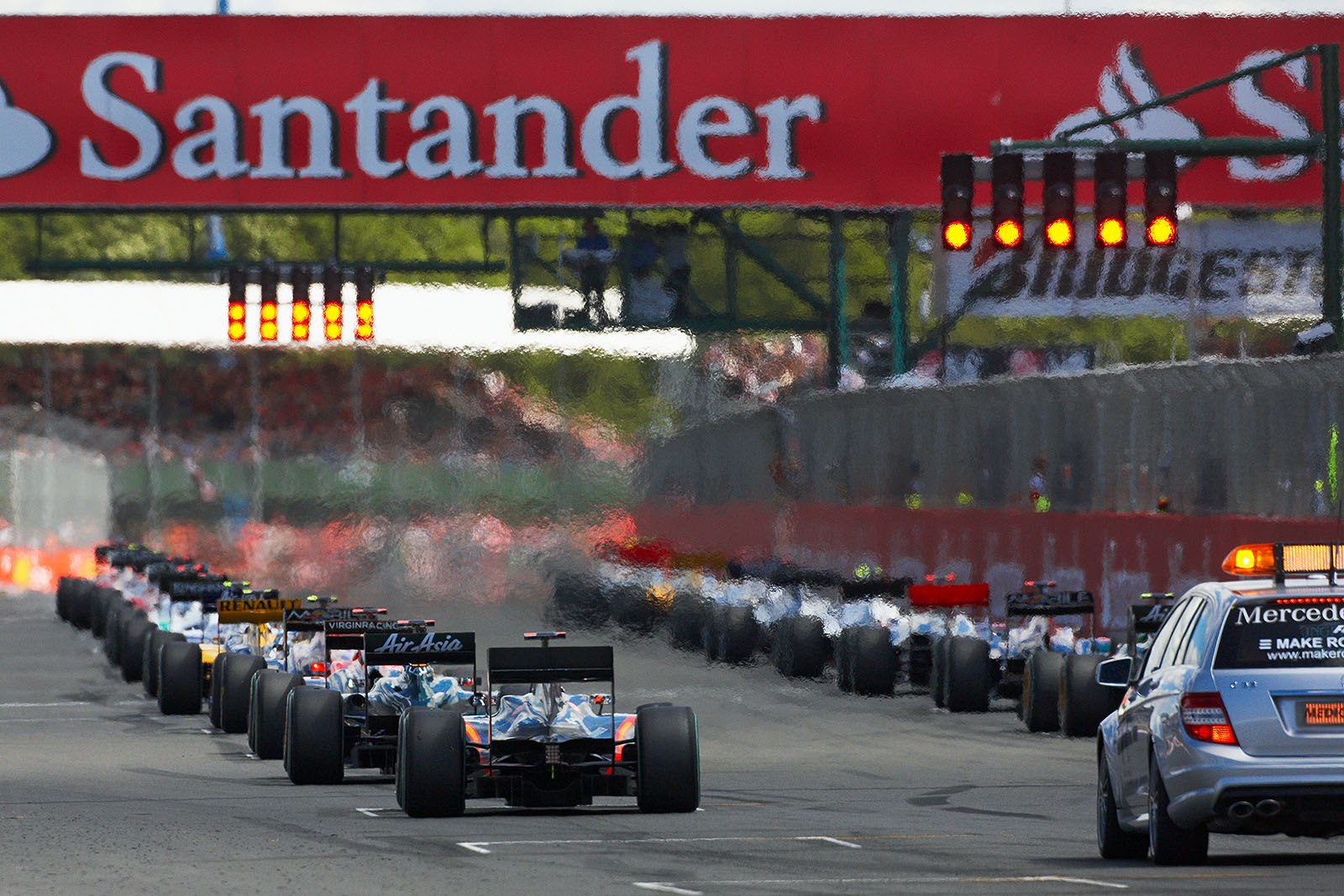 Hot air emitted by roaring engines cover the grid before the start of the British GP 2010