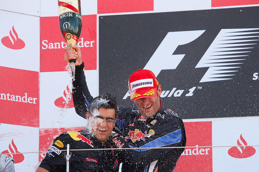 Champagne showers for Peter Prodromou, Red Bull Racing Head of Aerodynamics, and Race winner Mark Webber on the podium of the British GP 2010