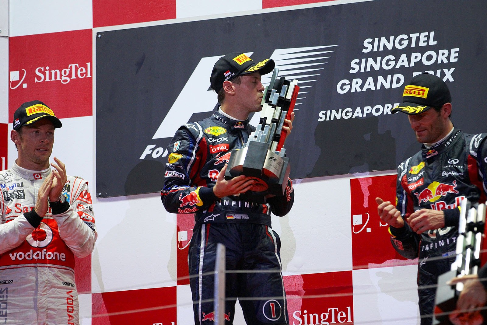 Red Bull Racing's race winner Sebastian Vettel kisses his trophy during podium ceremony
