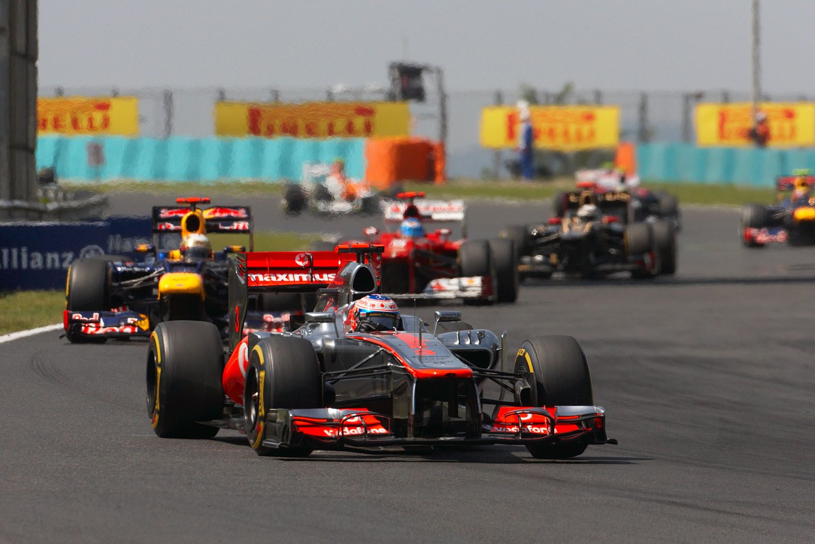 Jenson Button, McLaren Mercedes, in front of Red Bull's Vettel and Ferrari's Alonso