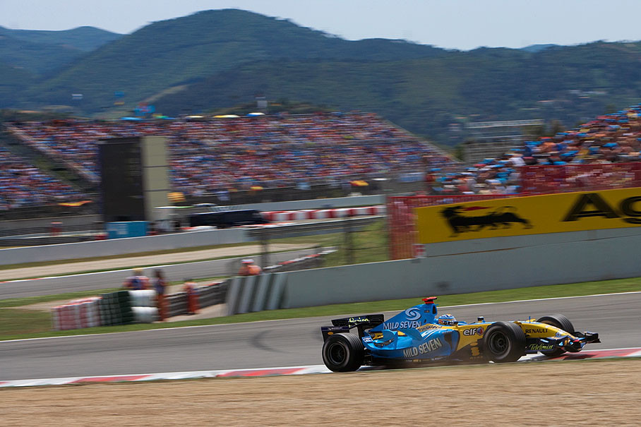 Fernando Alonso flying over a dusty curb