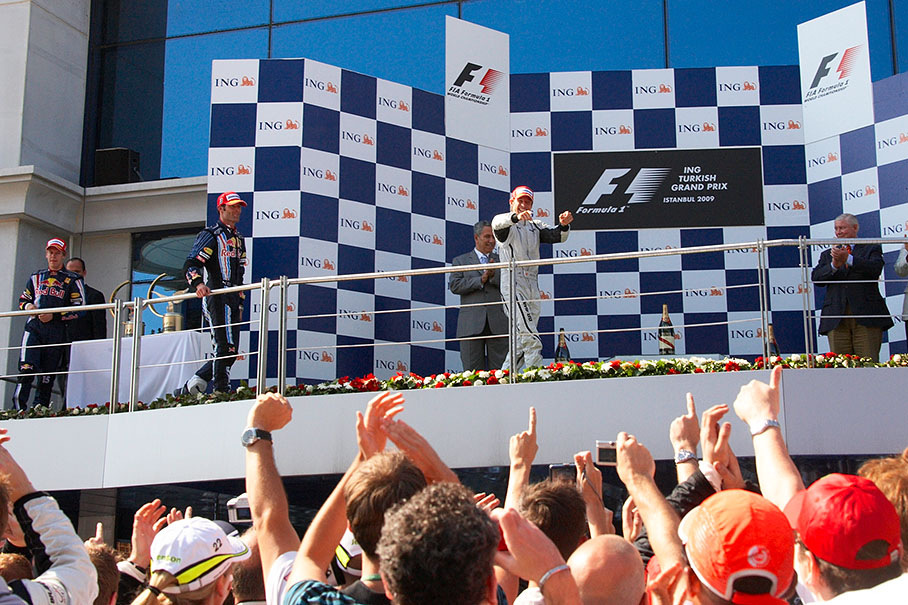 Race winner Jenson Button appears on the podium