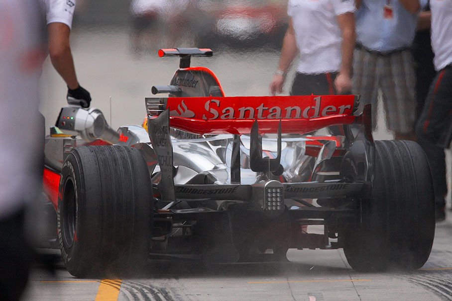 Lewis Hamilton puts rubber on the pitlane at McLaren pits