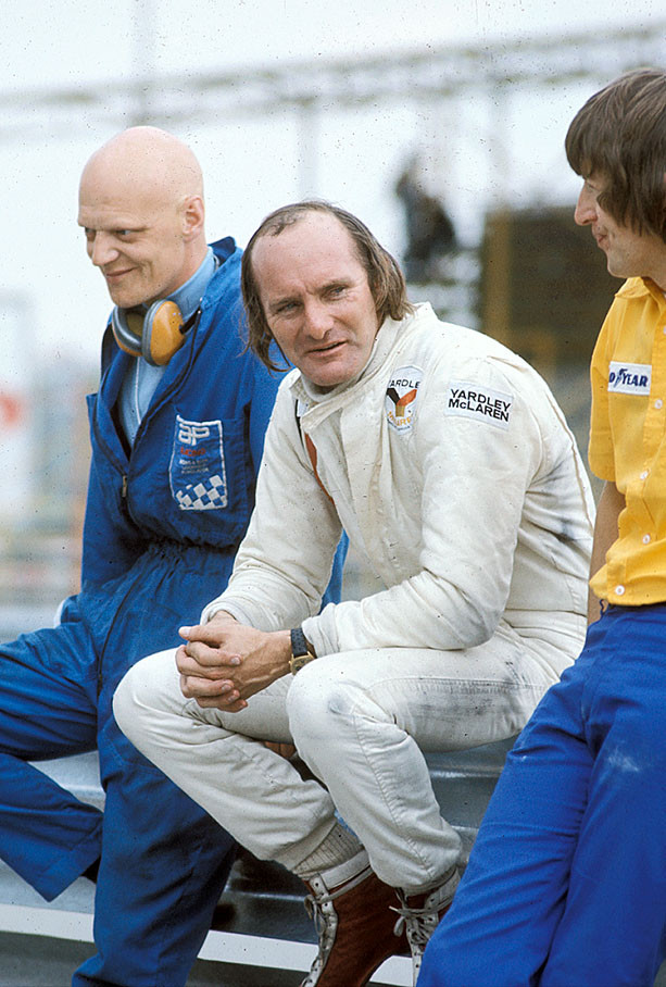 Mike Hailwood sits on the pitwall in a relaxed moment