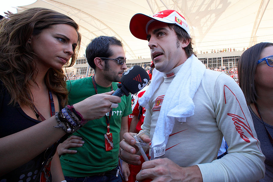 Fernando Alonso, Ferrari's new driver, is being interviewed on the grid