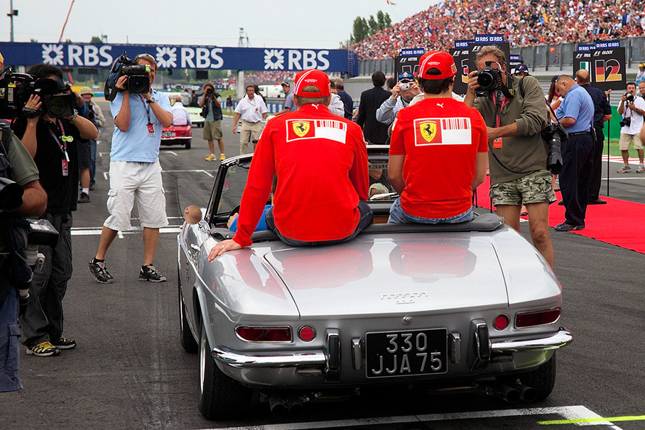 Ferrari team mates Felipe Massa and Kimi Raikkonen arrive at the crowded grid