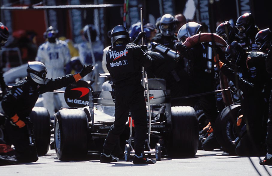 The McLaren-Mercedes crew performs a perfect pit-stop