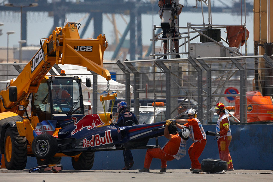 Mark Webber's destroyed Red Bull-Renault is removed from the track after a horrifying crash with Kovalainen, he walks away without injuries