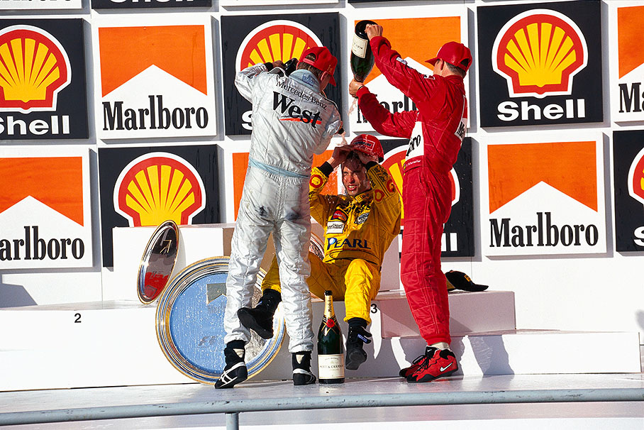 Heinz-Harald Frentzen became third and receives a good champagne shower from winner Hakkinen and second placed Schumacher