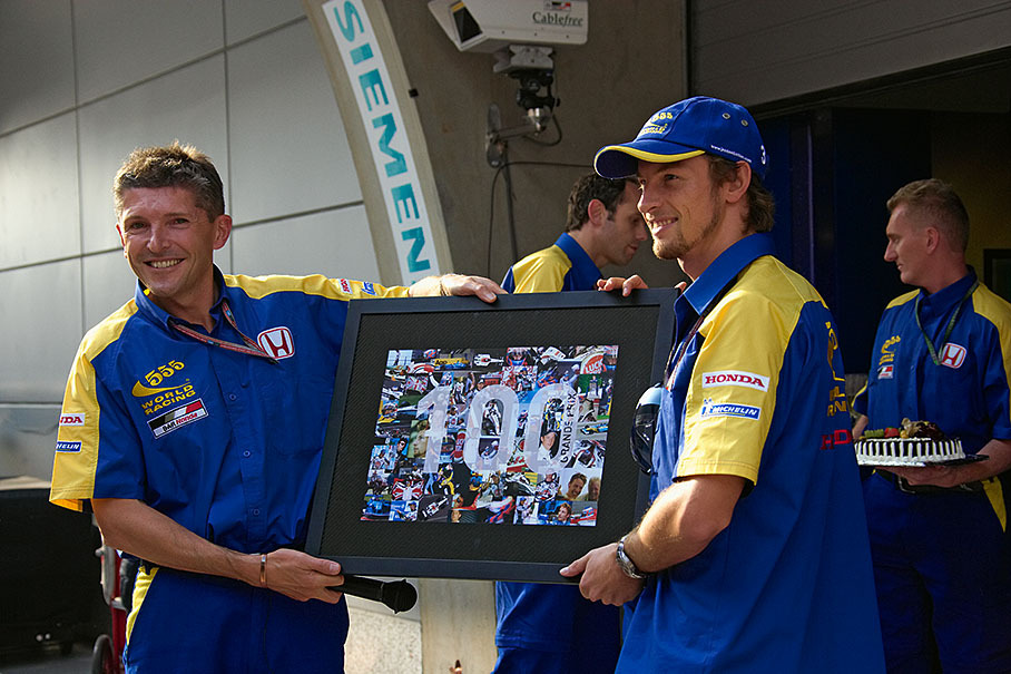 The celebration of Jenson Buttons’s 100th Grand Prix, alongside him BAR team manager Nick Fry.