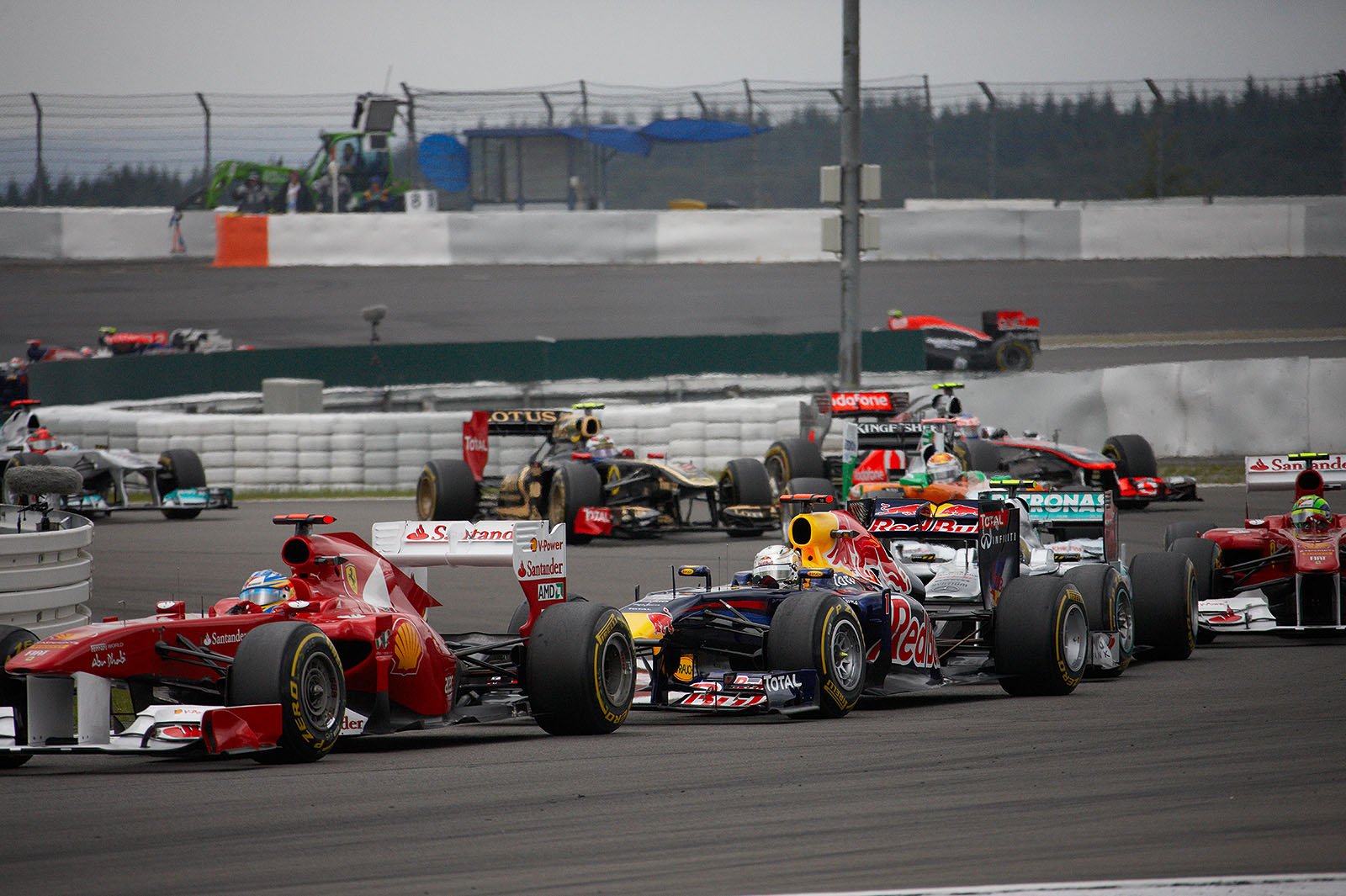 The field comes around Mercedes arena, Alonso leads fourth placed Vettel