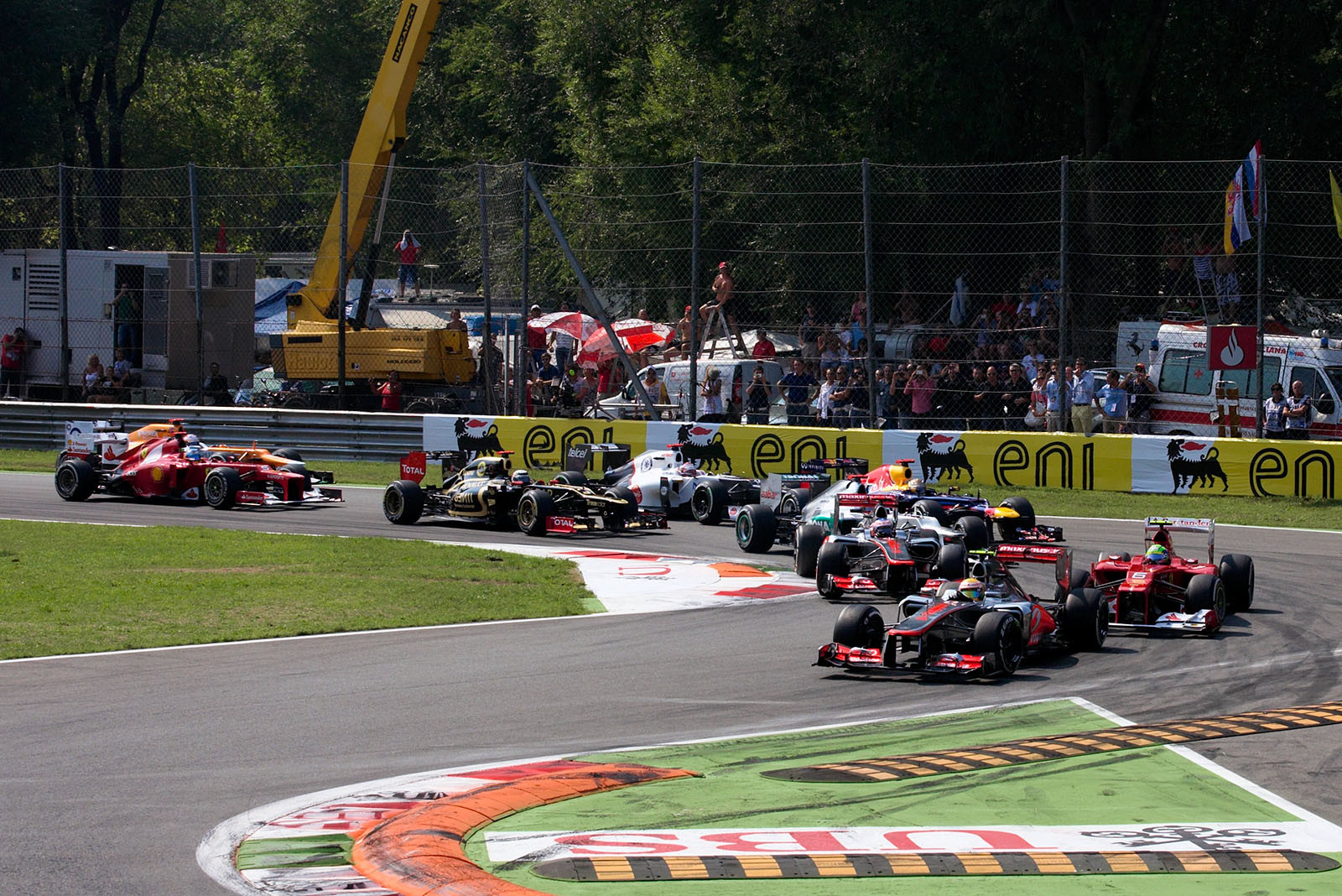 The start field squeezes through the first turns, Hamilton leads in front of Massa and Button