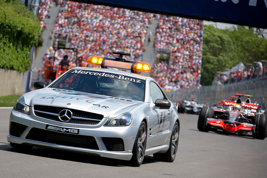 The safety car leads the queue with Hamilton in front