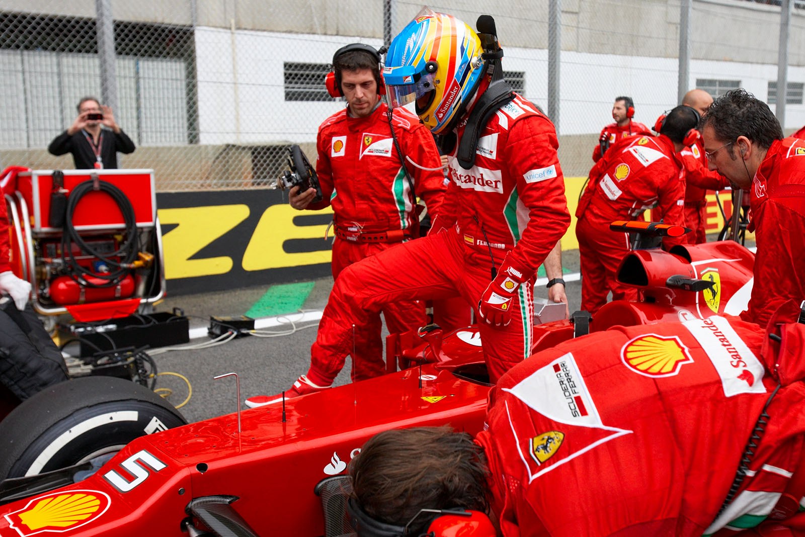 Fernando Alonso gets out of the Ferrari race car at the grid