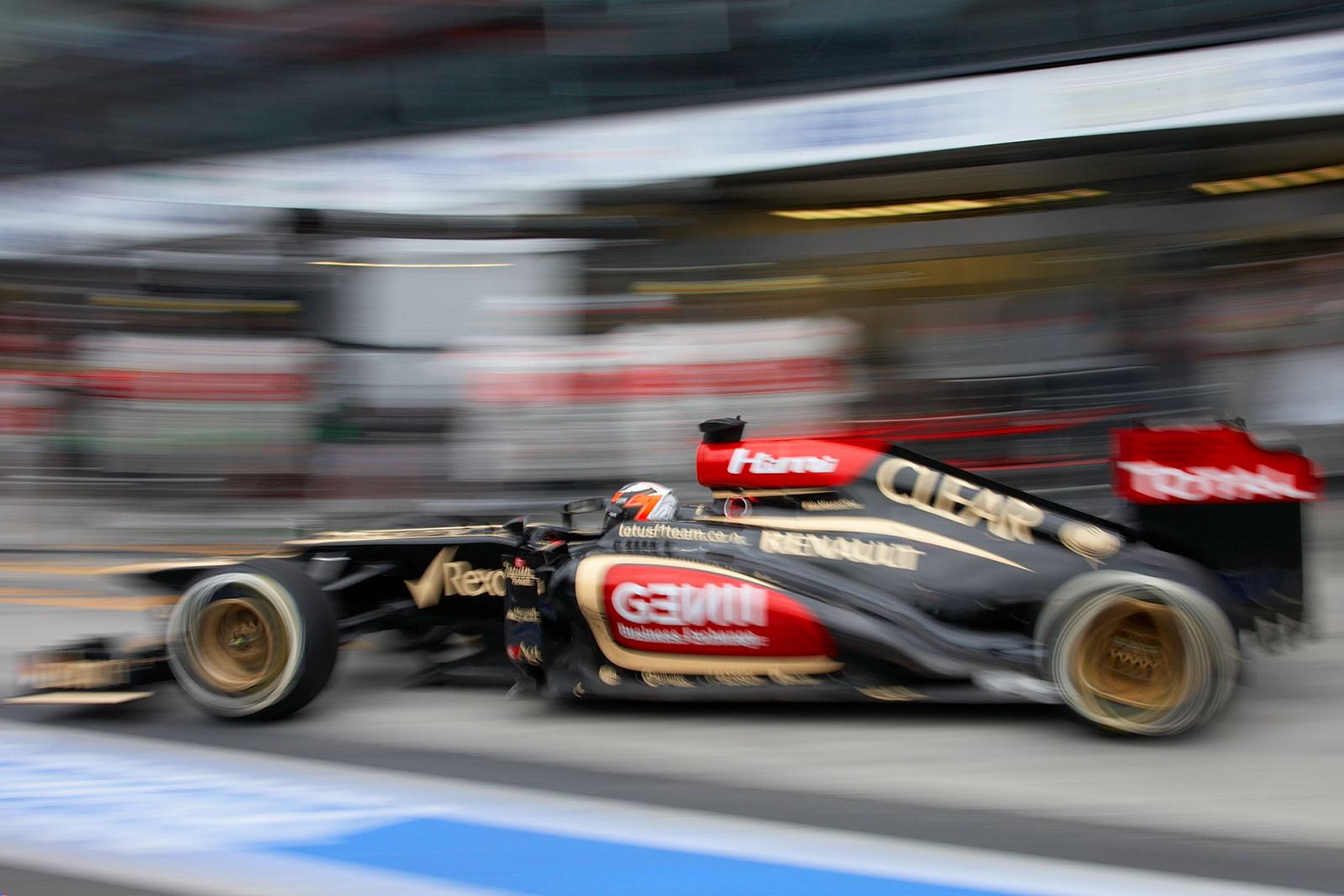 Soon race leader Kimi Raikkonen rushes out of Lotus pits